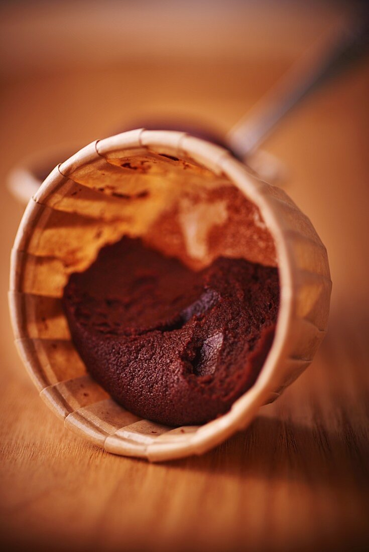 Remains of chocolate cake in a paper case