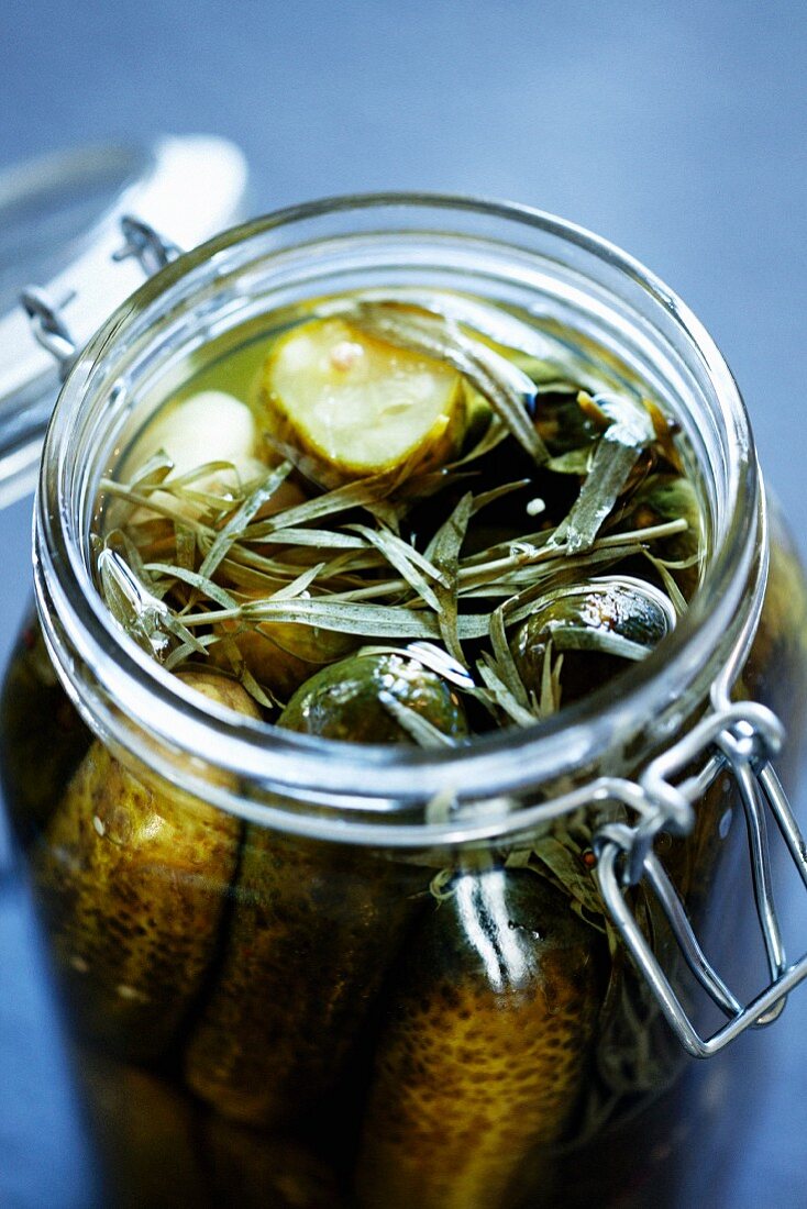 A jar of gherkins with tarragon