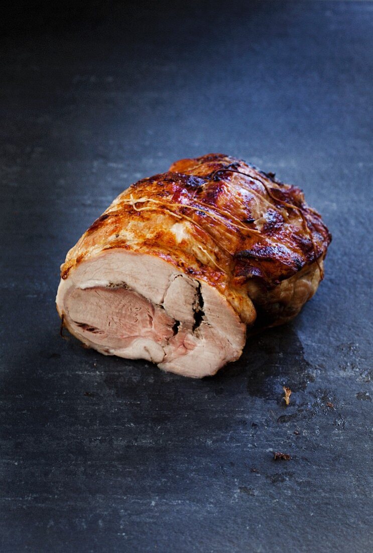 Roast pork on a grey stone platter