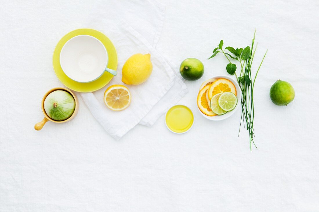 A teacup, lemons and limes