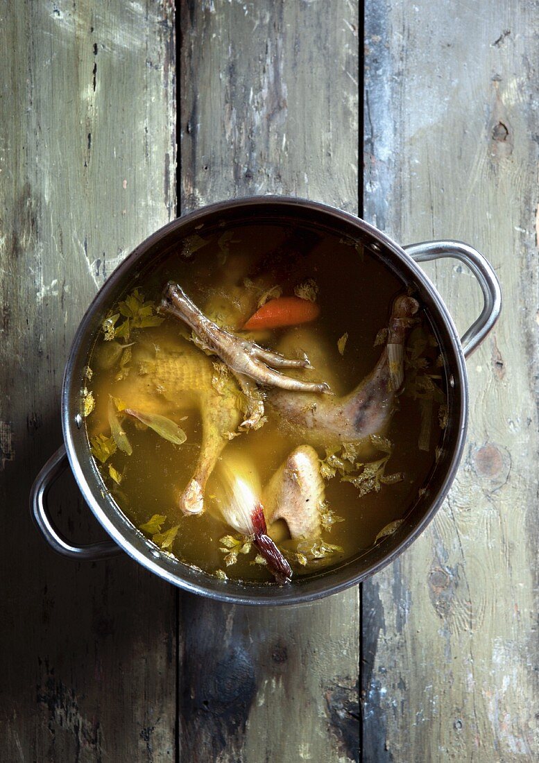 Chicken soup with carrots in a saucepan