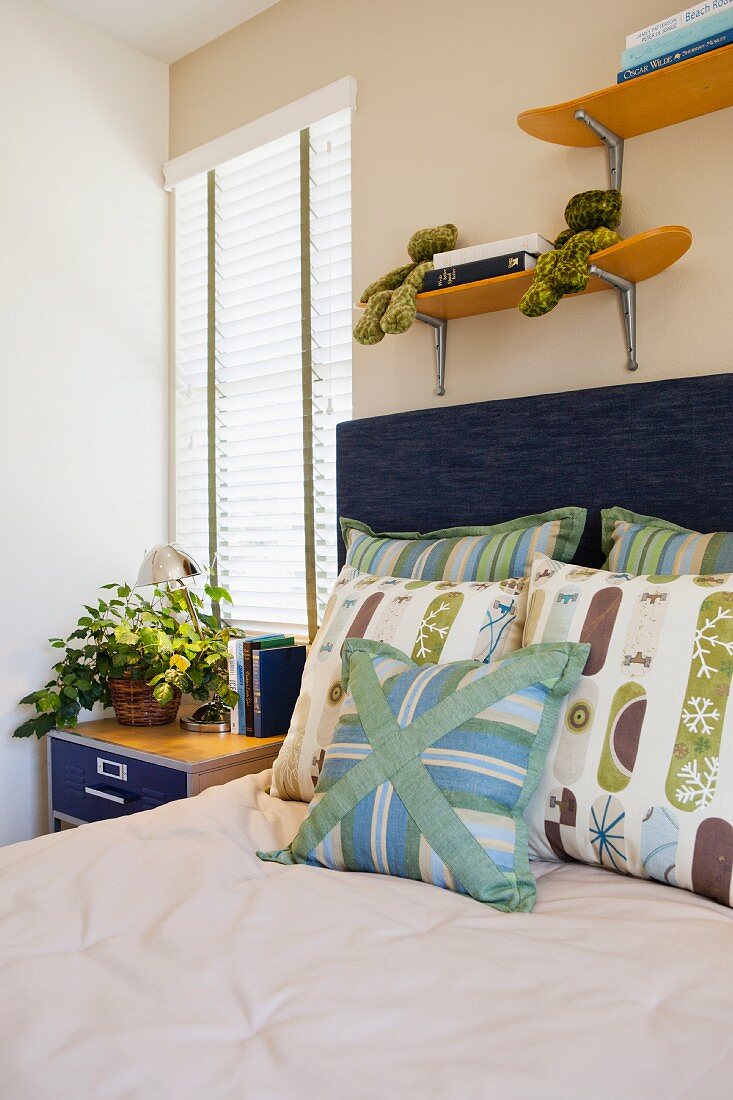 Scatter cushions on bed; San Marcos; California; USA