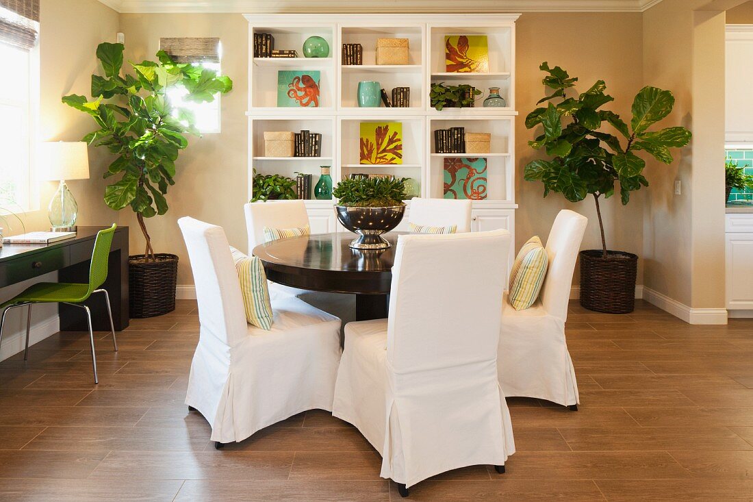 Loose-covered chairs around dining table; Azusa; California; USA