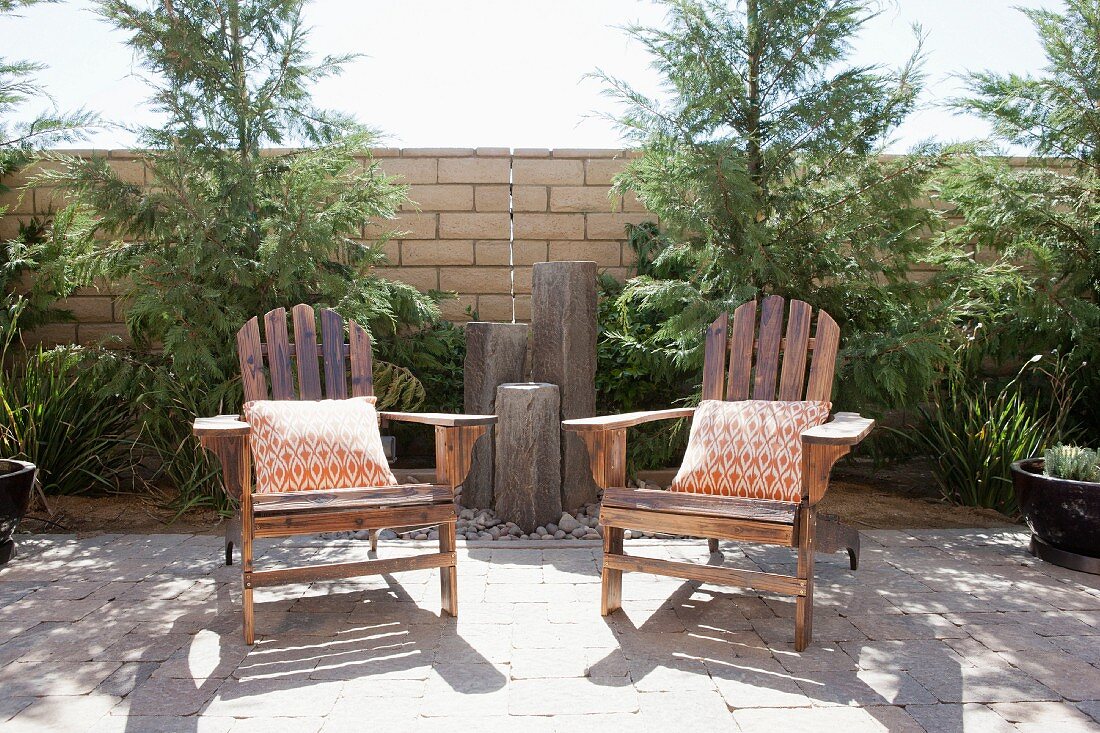 Wooden armchairs on sunny patio