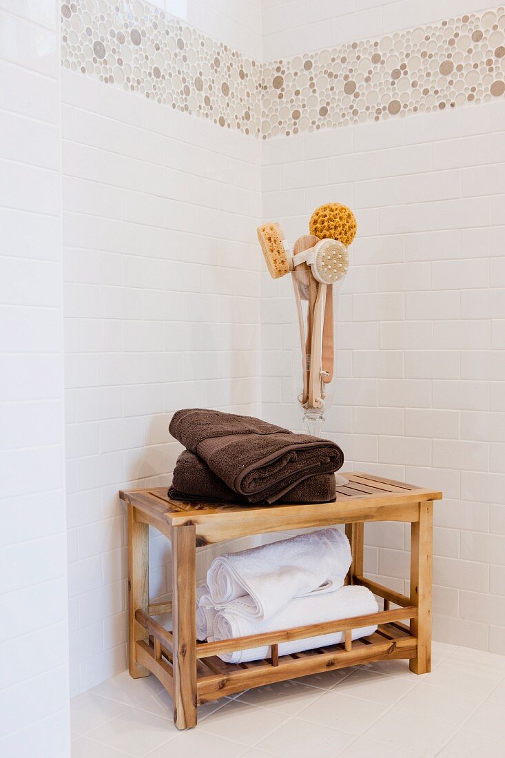 Towels on wooden table and bath brushes in bathroom; Rancho Mission Viejo; California; USA