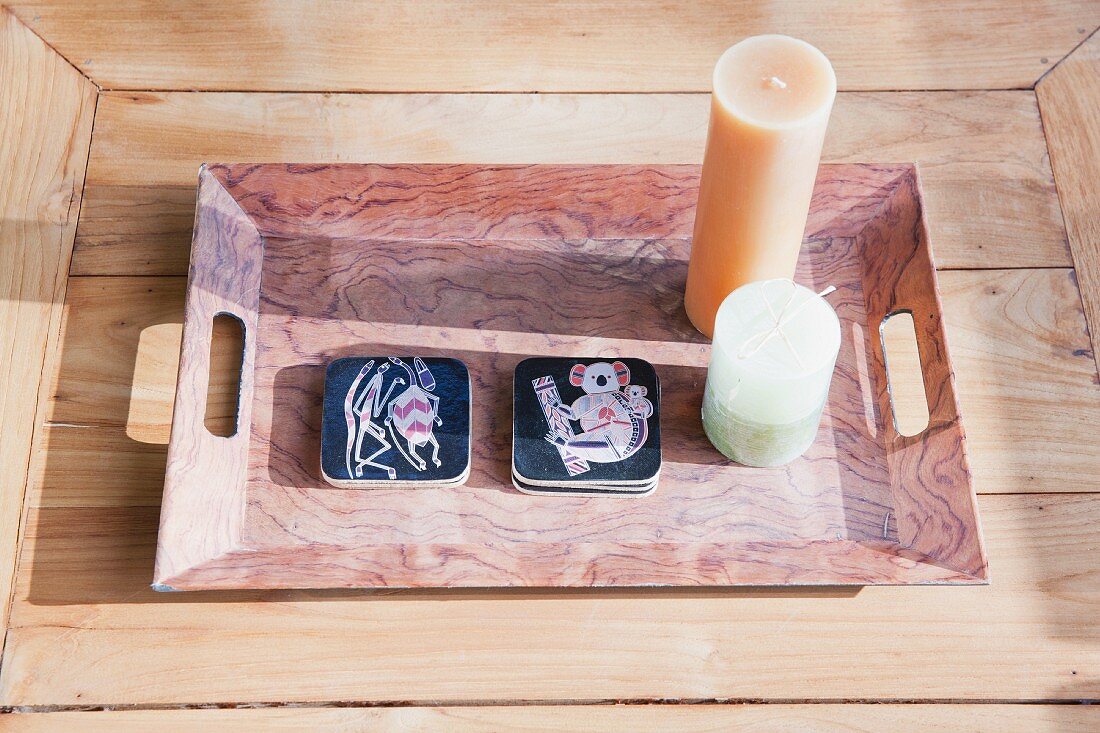 Candles on tray on wooden table in sunlight; Dana Point; California; USA