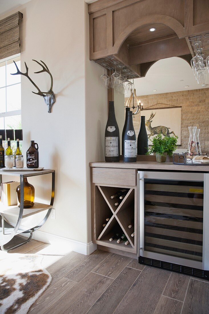 Wine bottles in rack and on counter