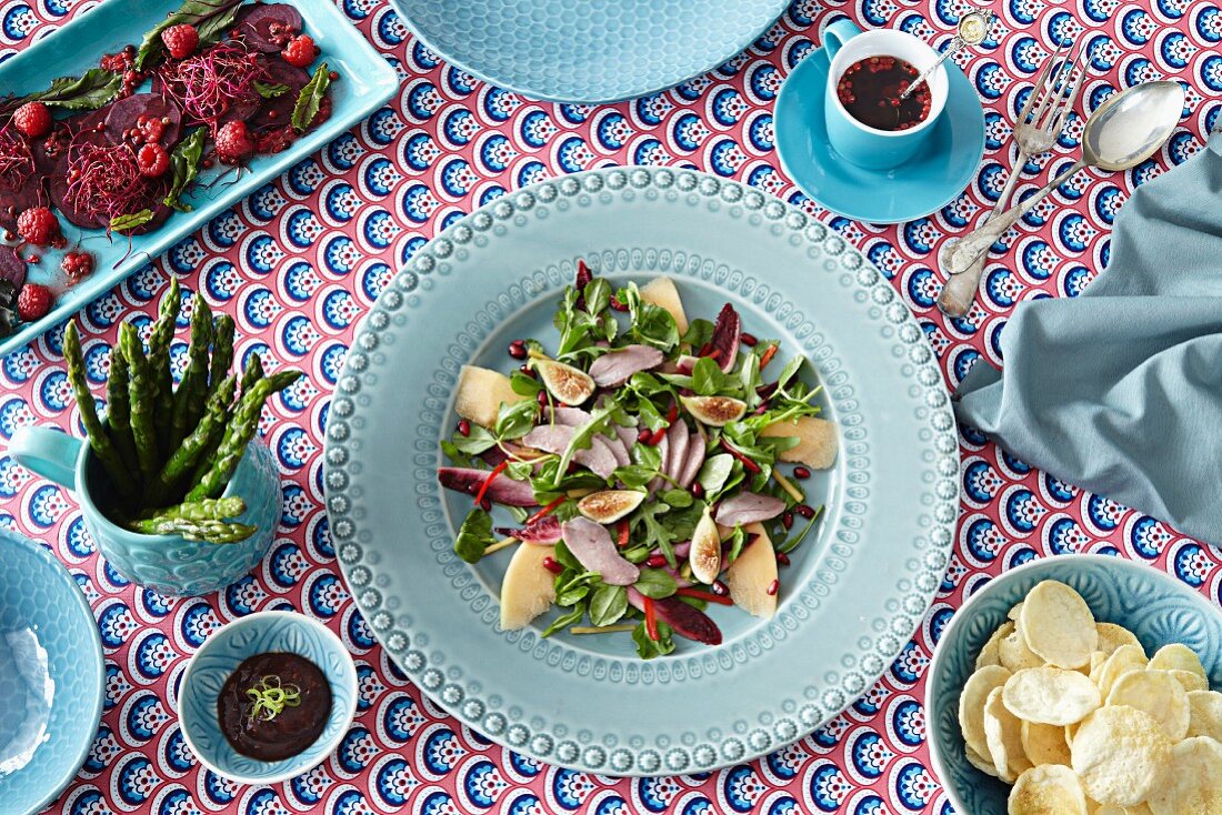 A bird's eye view of beetroot and herb salad with dressings