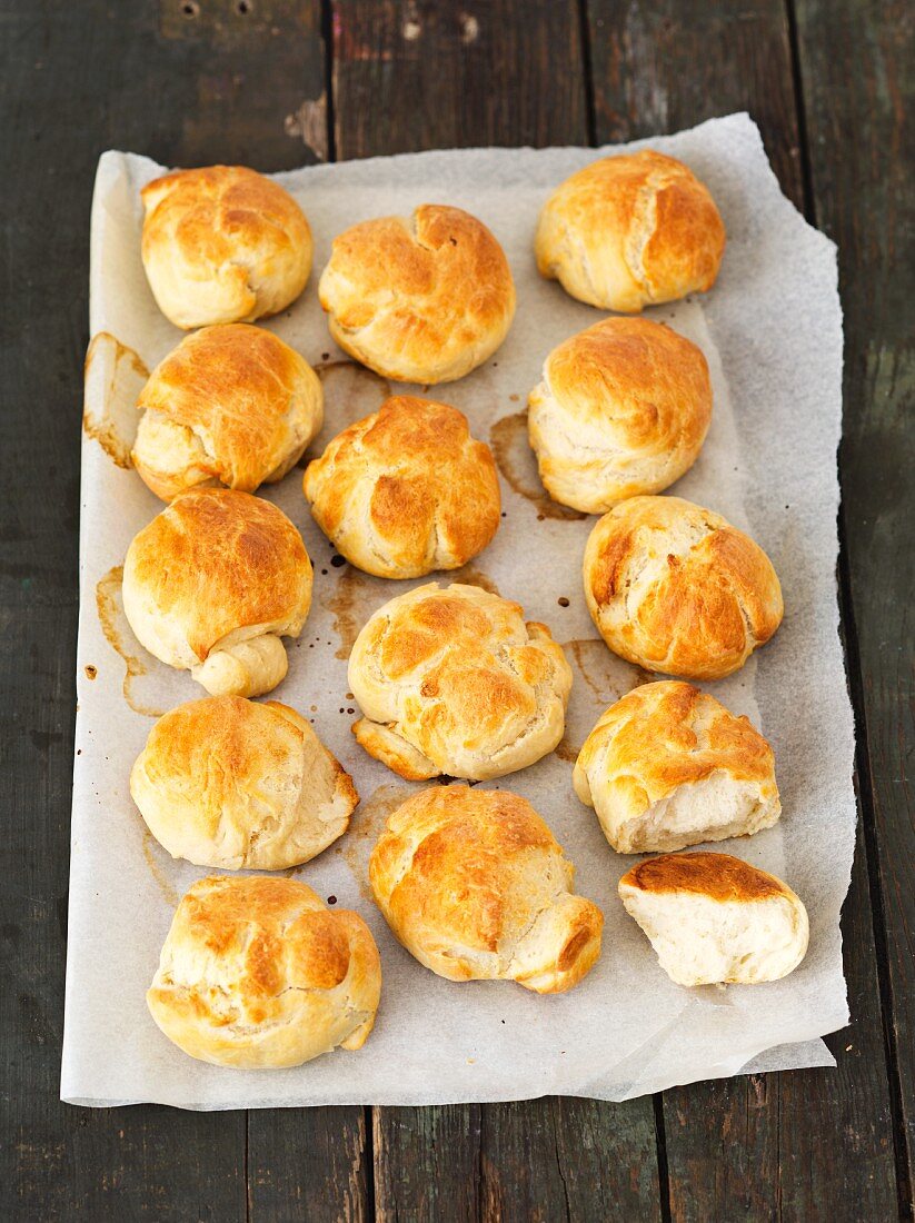 Freshly baked bread rolls on parchment paper