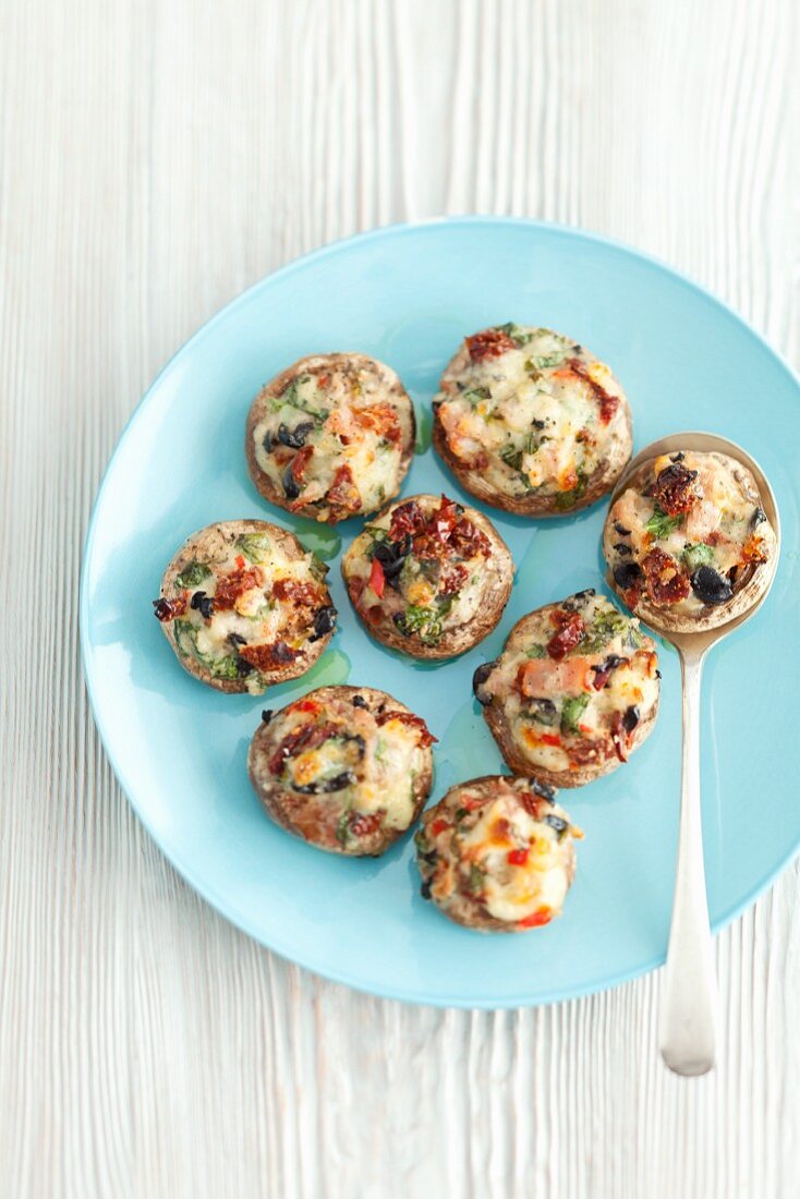Mushrooms stuffed with dried tomatoes, mozzarella and herbs