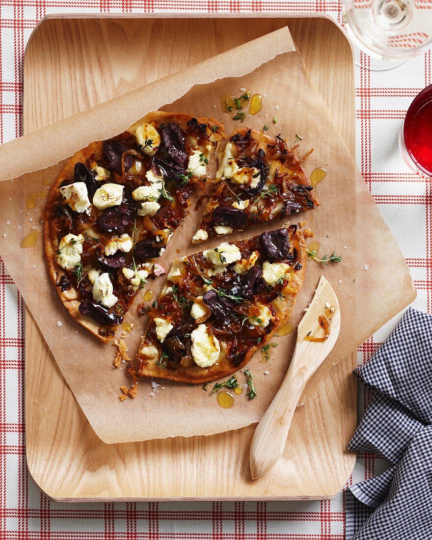 Caramelized onion pizza on a chopping board