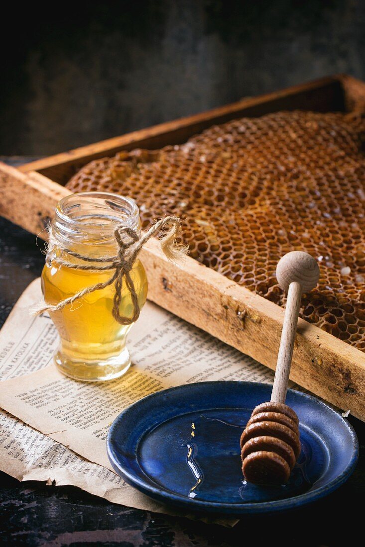 A jar of honey with honeycombs