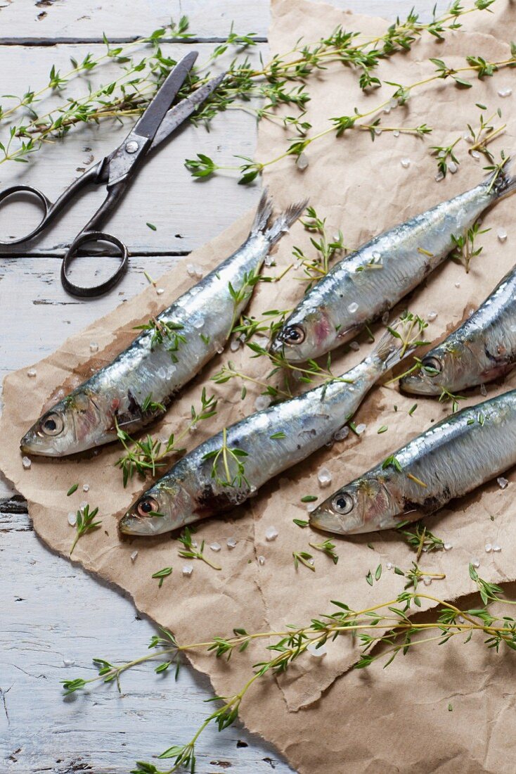 Fresh, raw sardines sprinkled with salt and thyme