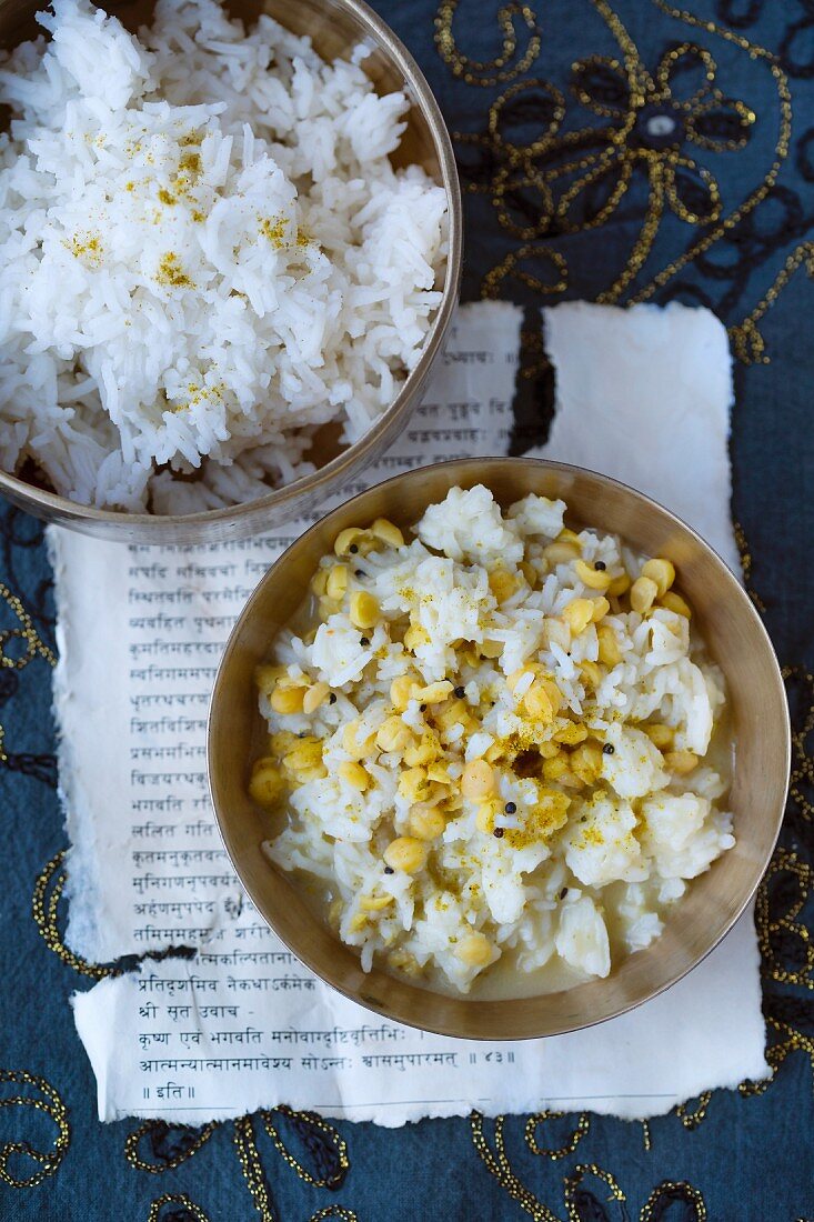 Basmati rice, chana dhal (yellow lentils) and brown mustard seeds on a piece of Sanskrit text (India)