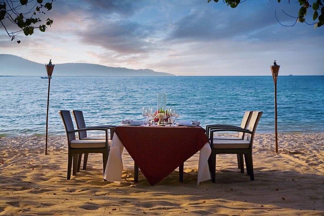 A table on a beach in Malaysia laid for dinner