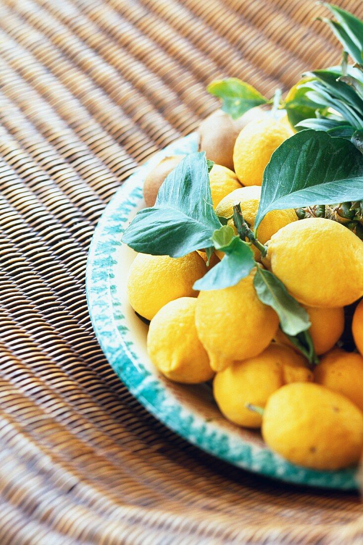 Fresh lemons on a ceramic plate