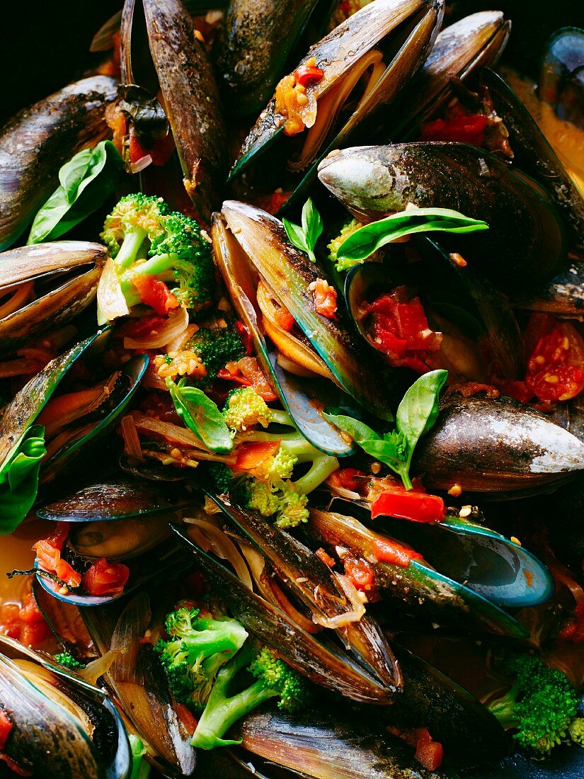 Close up of mussels with broccoli in tomato sauce