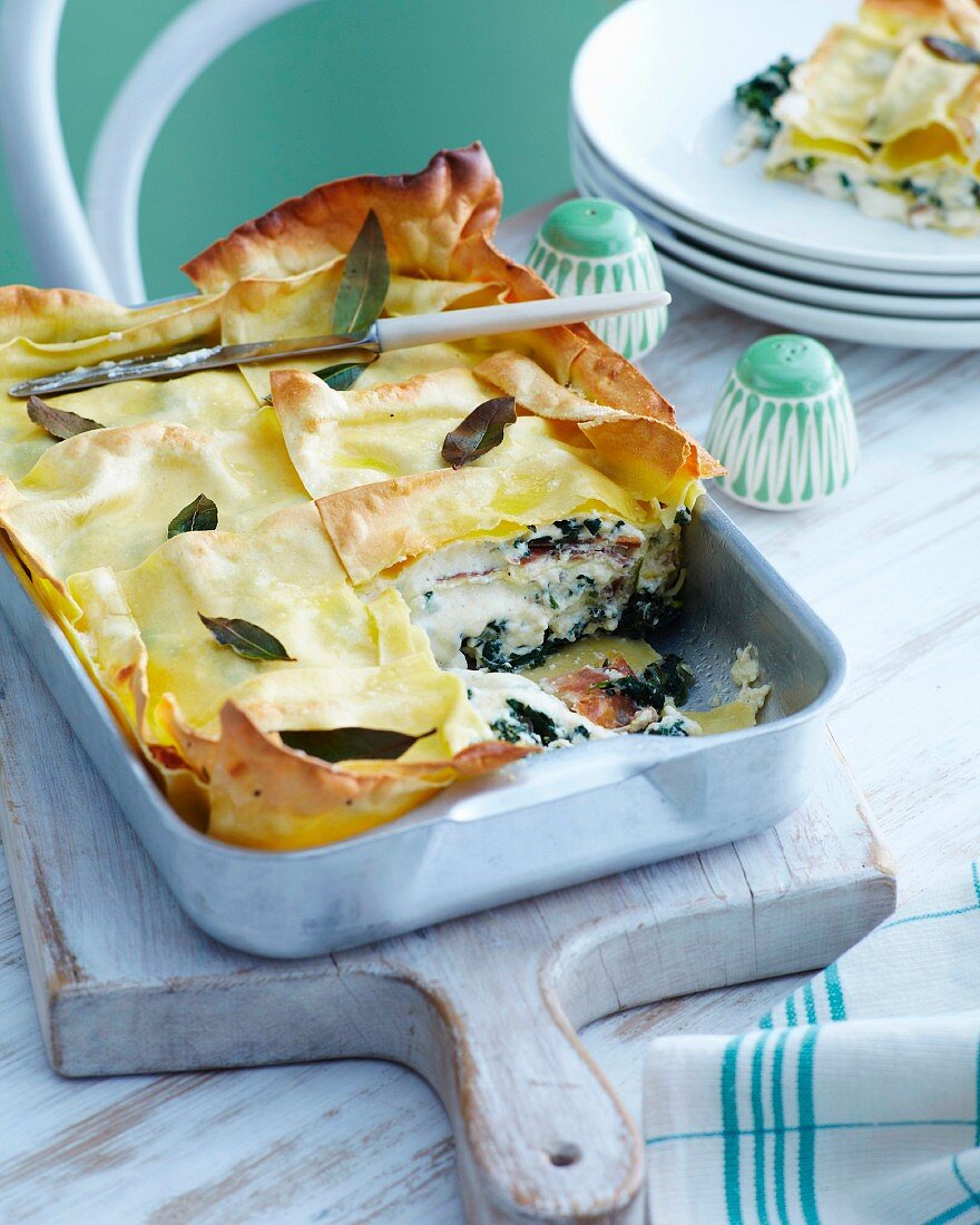 Rocket and ham lasagne with sage in a baking dish