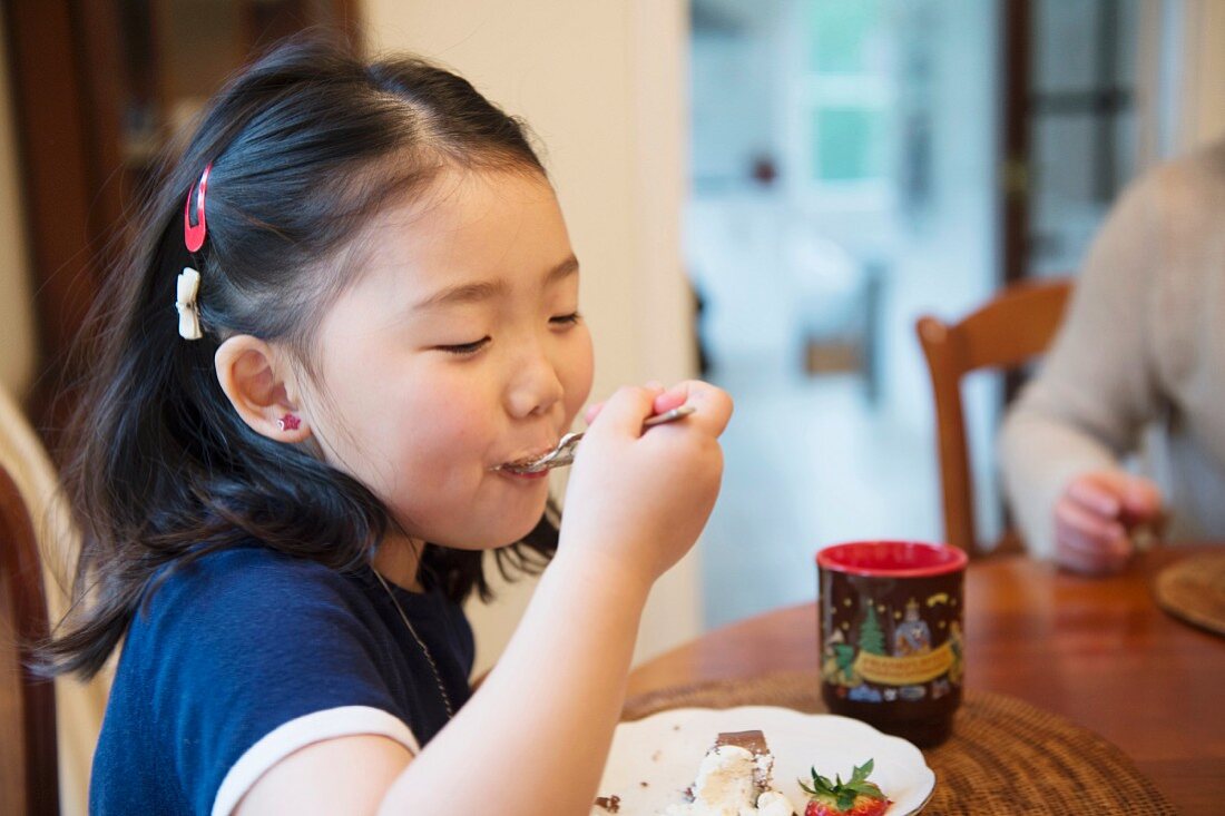 A little girl eating cake