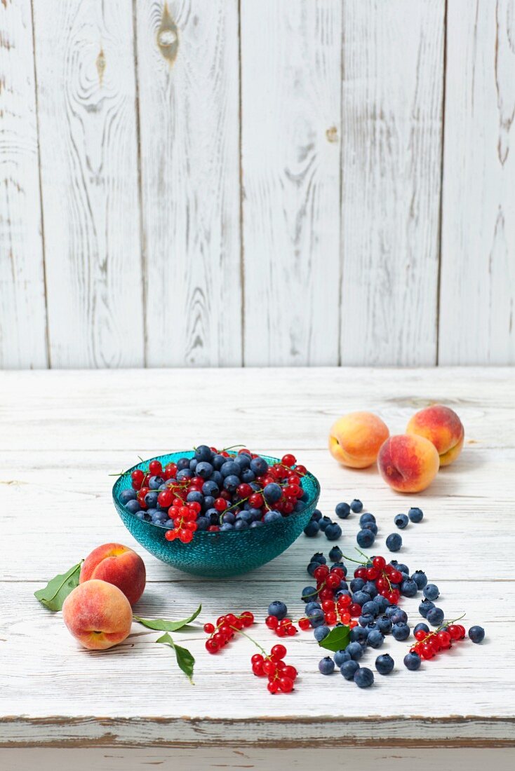 An arrangement of blueberries, redcurrants and peaches
