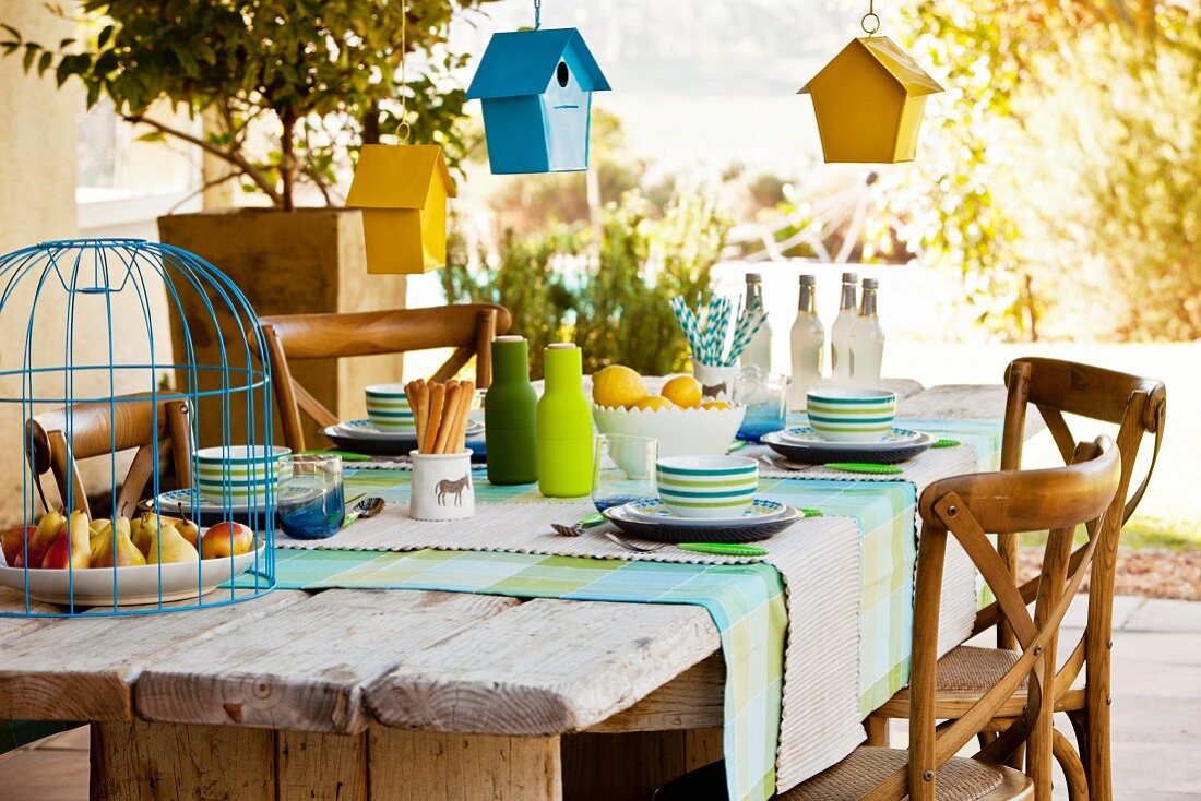 Bird houses hung over set table