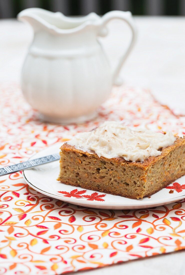 Ein Stück Karottenkuchen mit Äpfeln, Zucchini und Cidreglasur