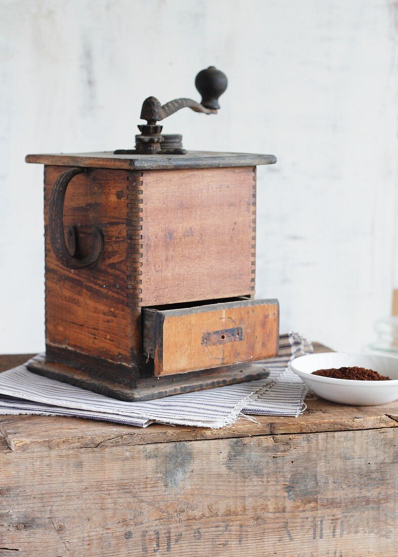 An antique wooden coffee mill