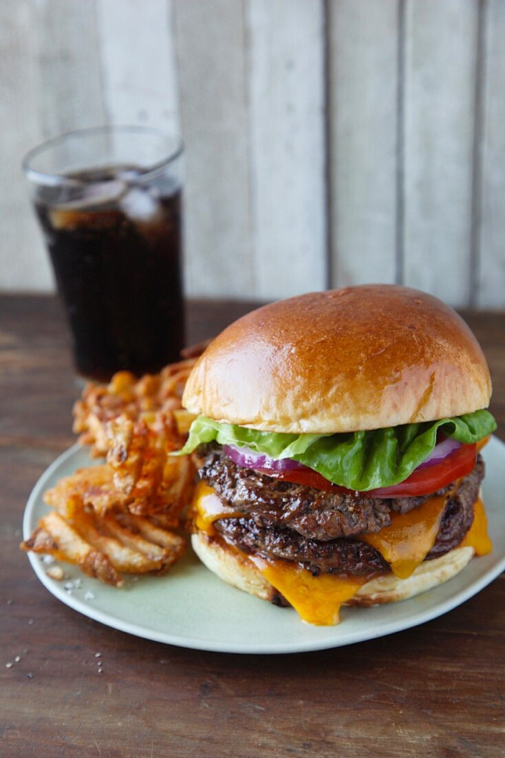 A cheeseburger with waffle fries