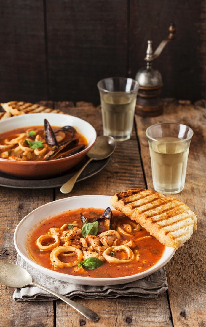 Seafood soup with tomatoes and grilled bread