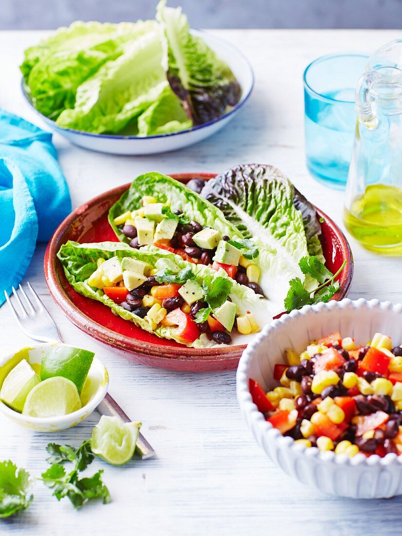 Spicy kidney bean and corn salad with avocado and peppers served in cos lettuce leaves