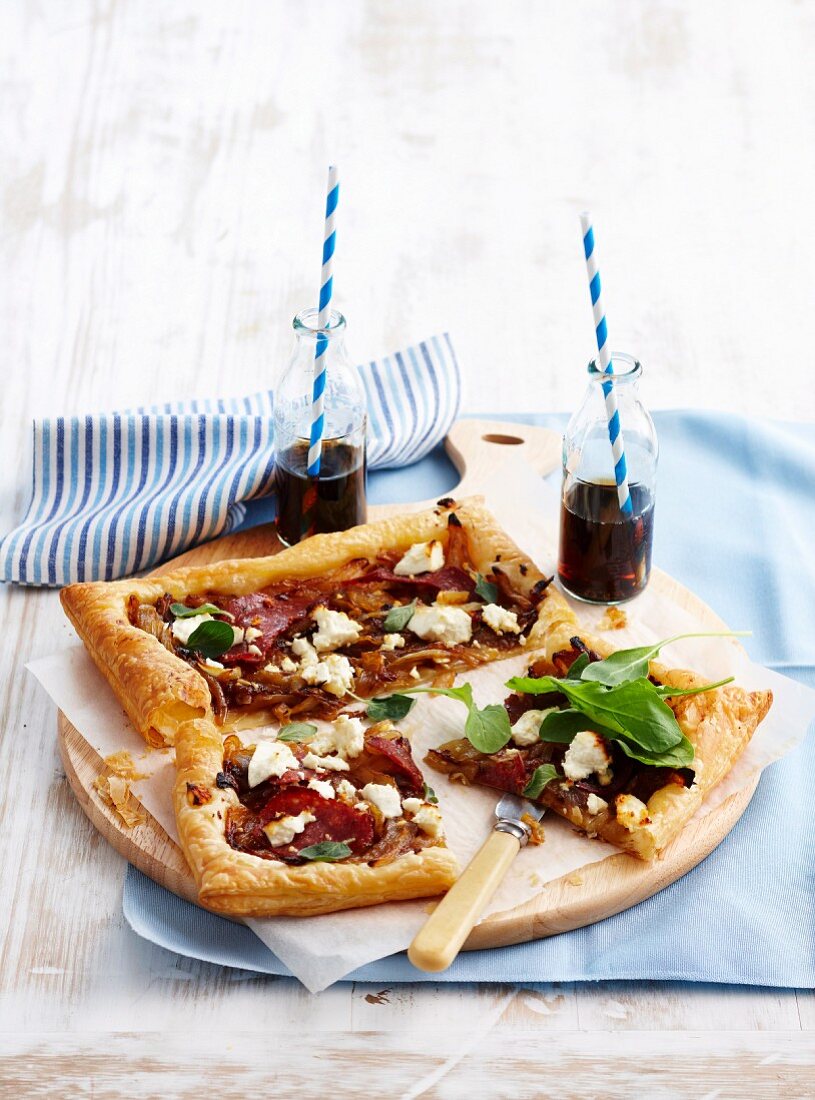 Caramelised onion tarts with salami and feta cheese