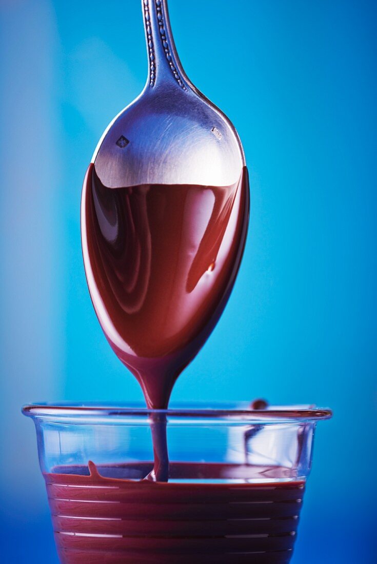 Liquid chocolate dripping from a spoon