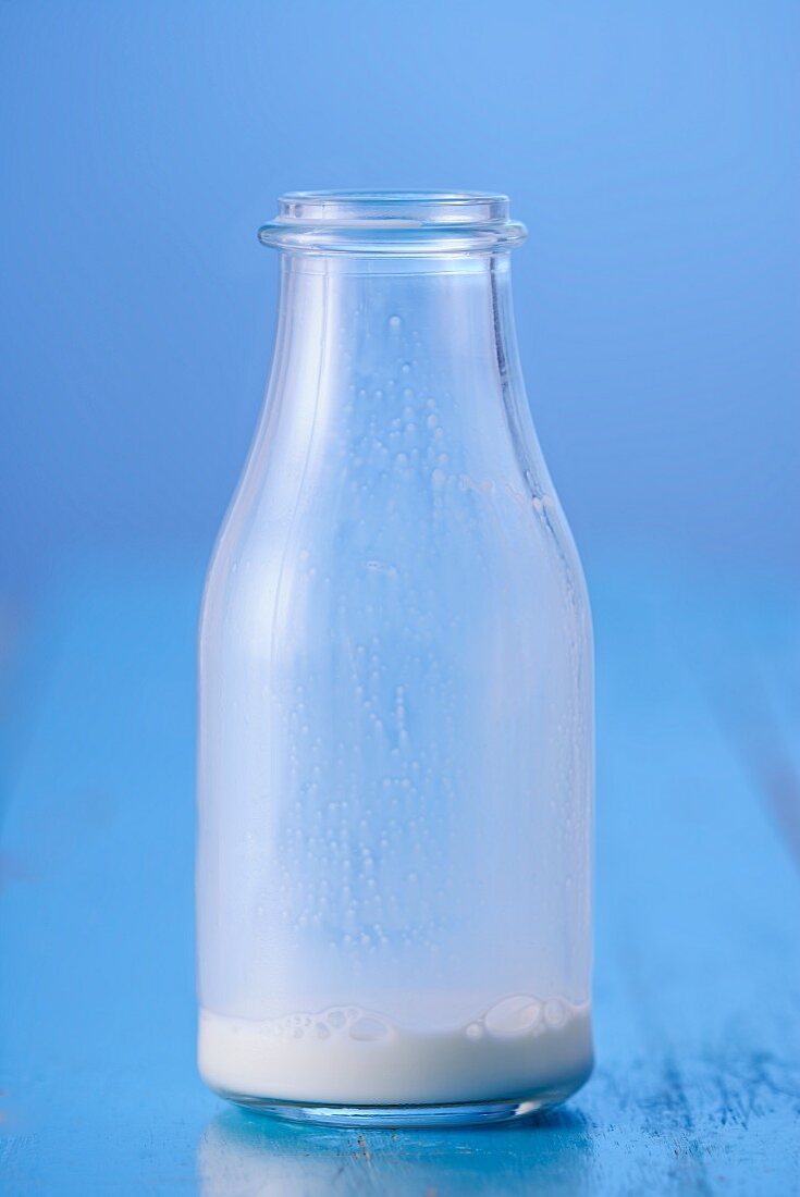 The remains of milk in a glass bottle