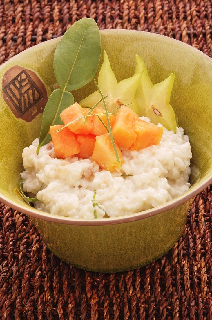 Thai coconut rice pudding with papaya and star fruits