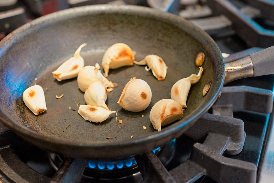 Garlic being fried in a pan