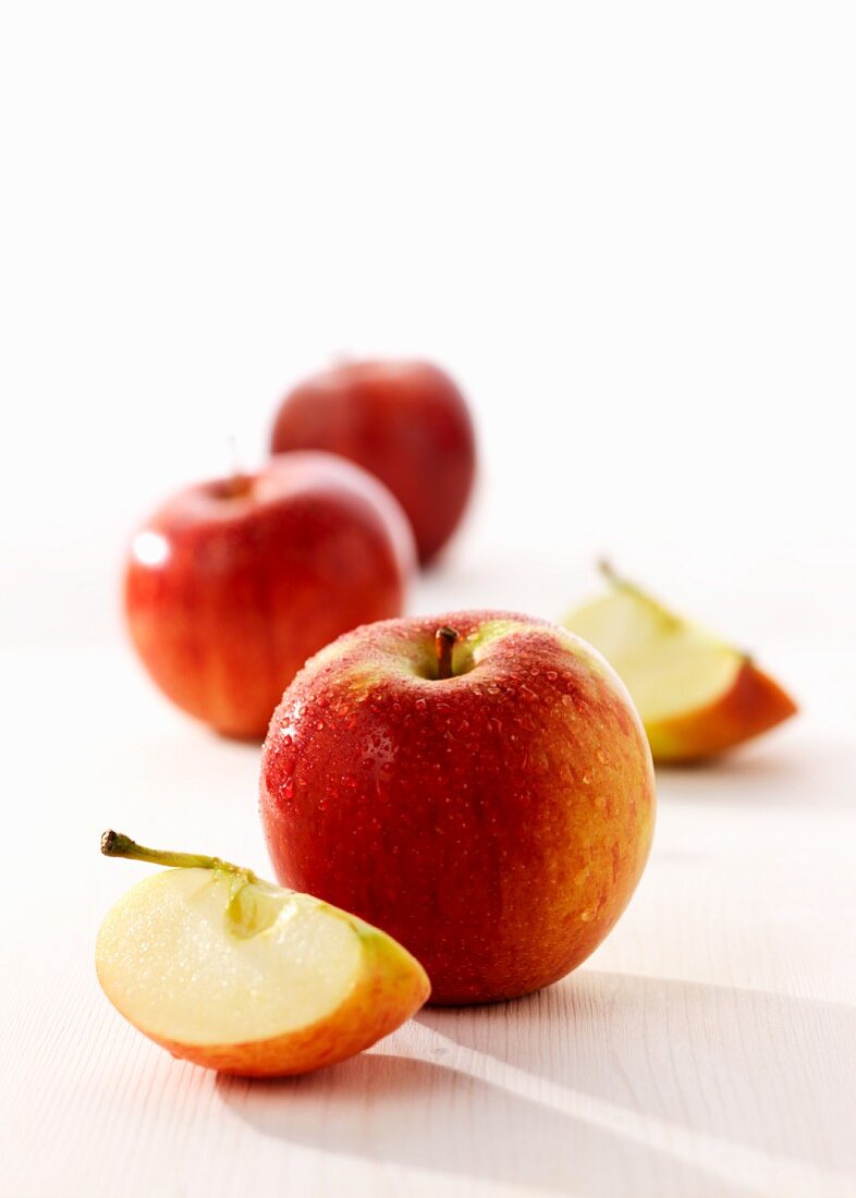 Fresh red apples, whole and sliced