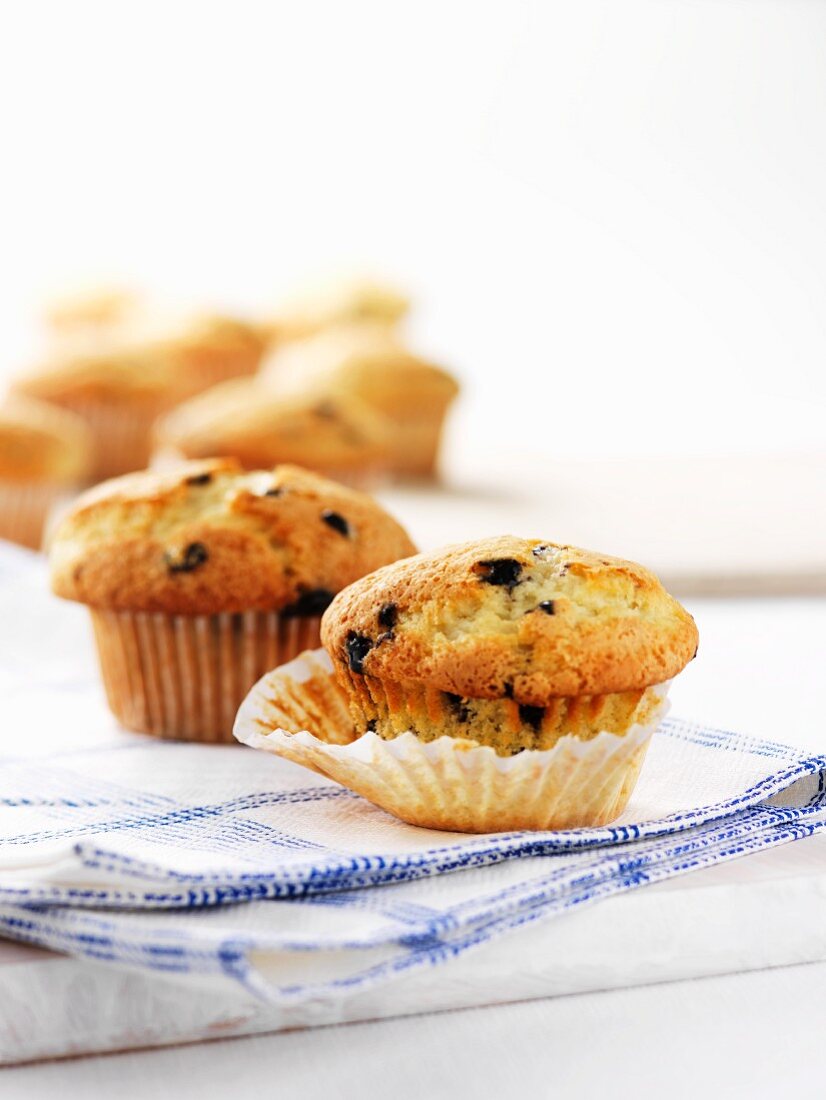 Blueberry muffins on a tea towel