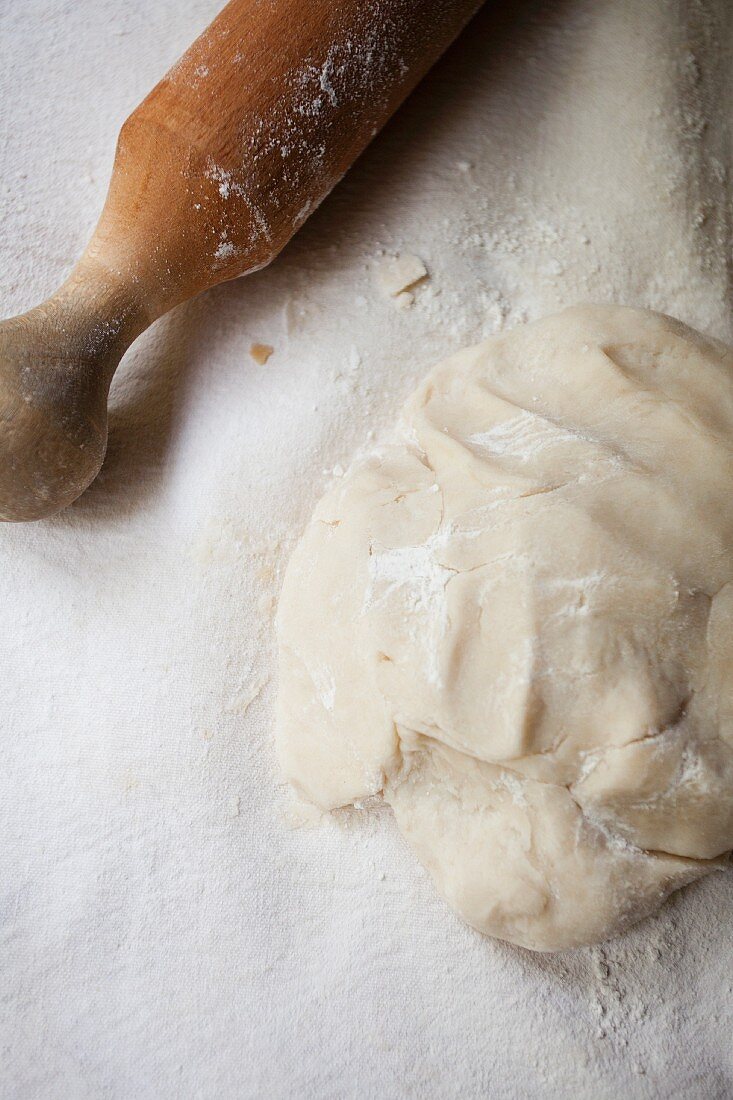 Yeast dough and a rolling pin