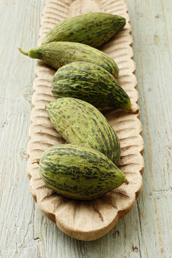 Cucumber melons in a wooden dish