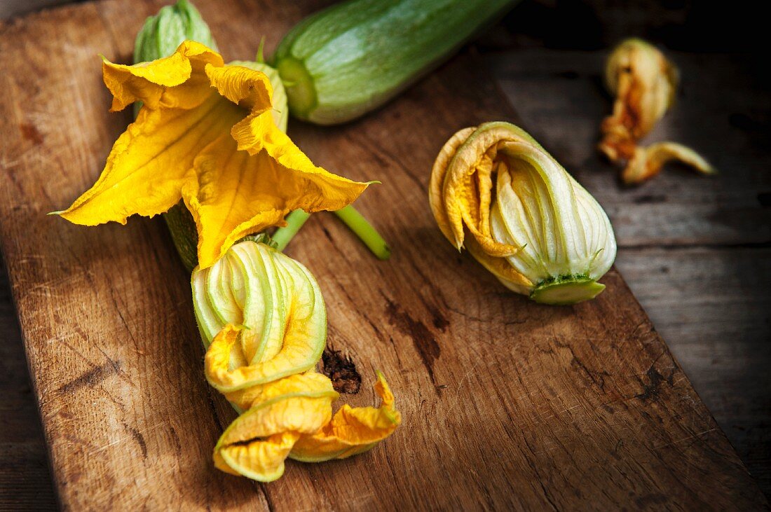 Courgette flowers on a wooden board