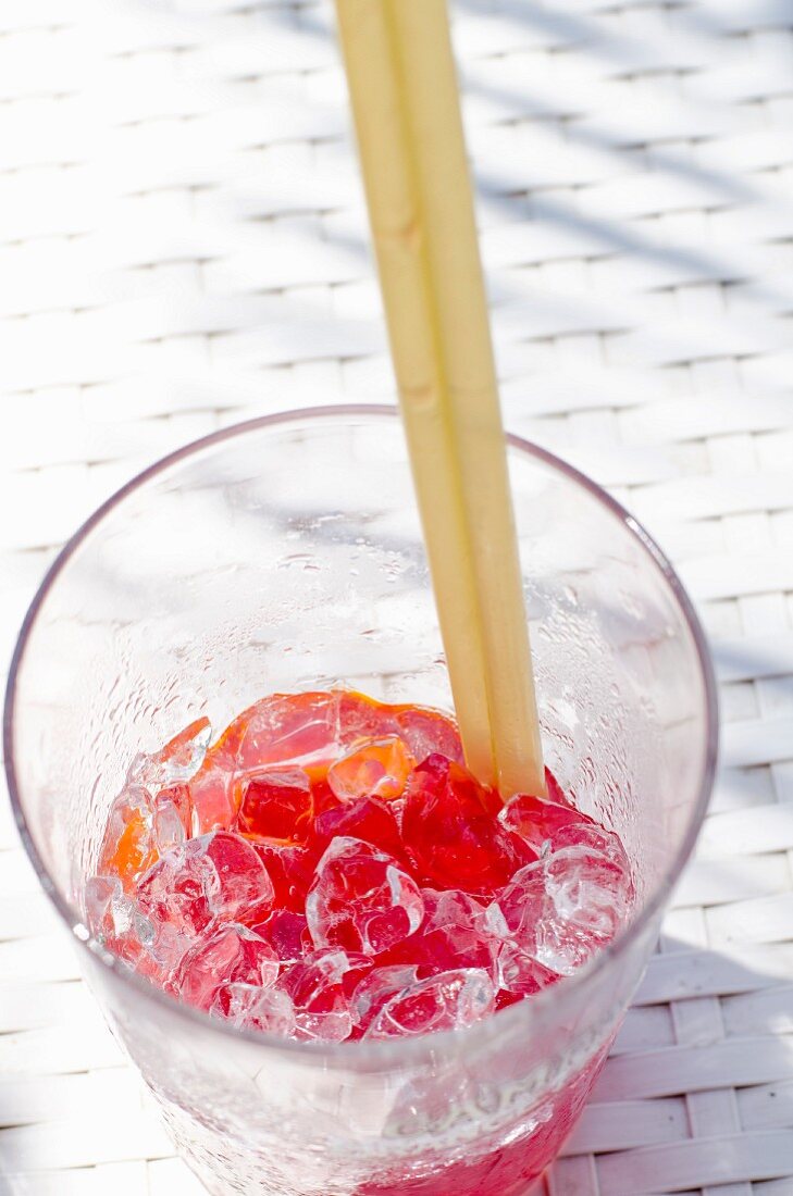 Aperol Spritz cocktail with crushed ice and two straws
