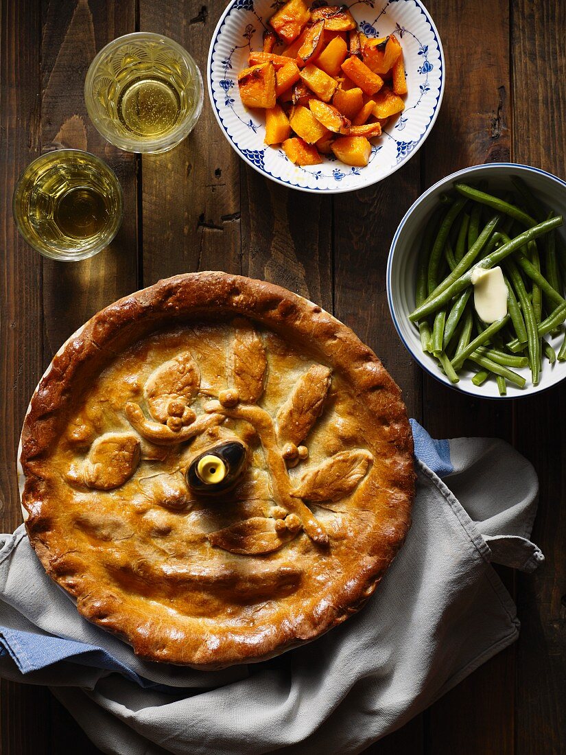 A pie with sides of vegetables