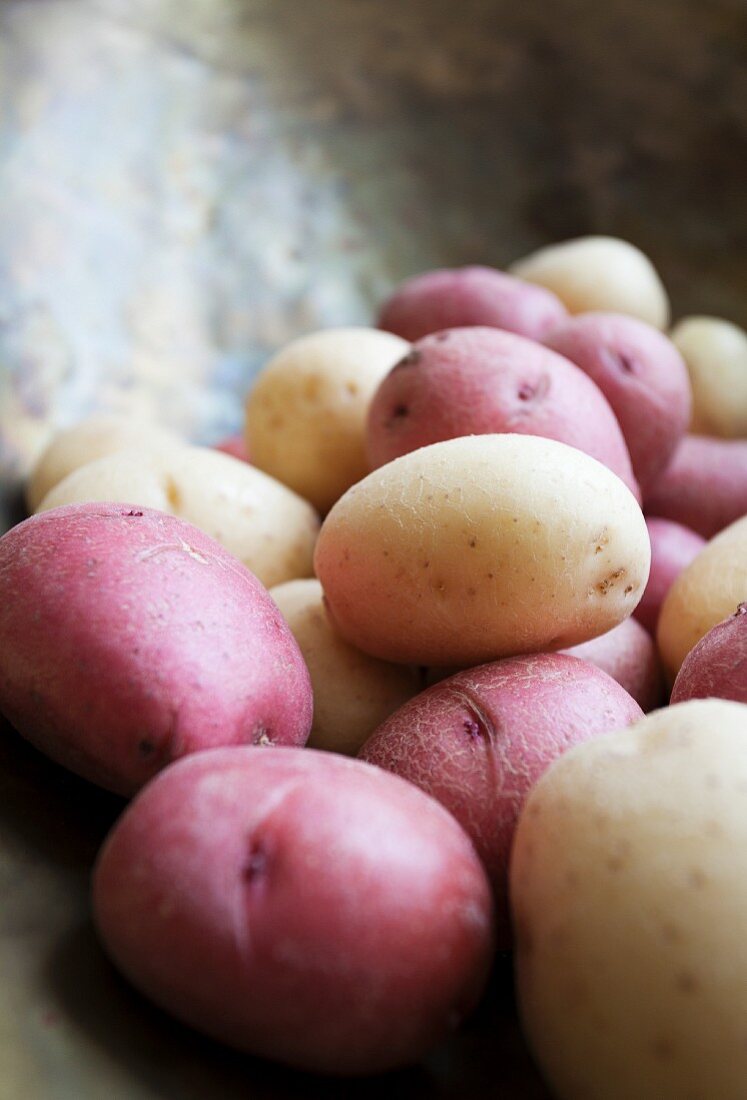 Various potatoes on a pair of old kitchen scales (close-up)