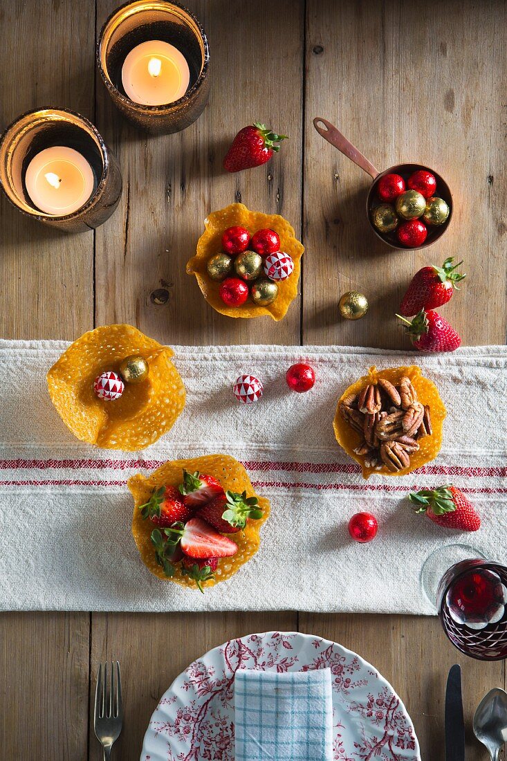 Wafer bowls filled with pralines, strawberries and nuts for Christmas