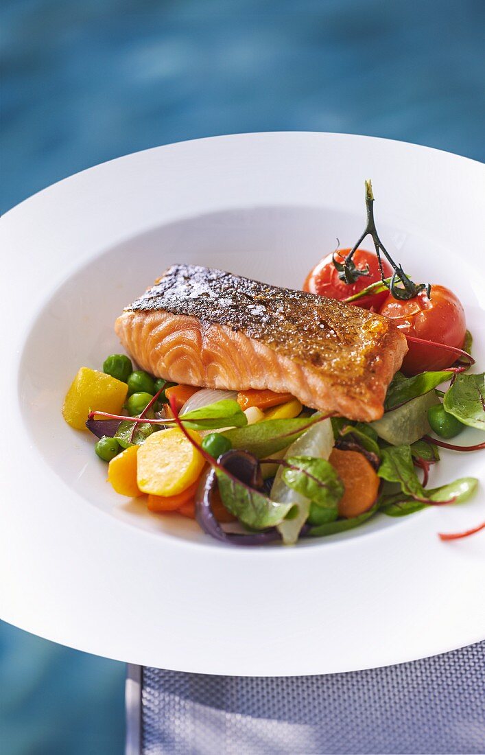 Salmon fillet on a bed of vegetables