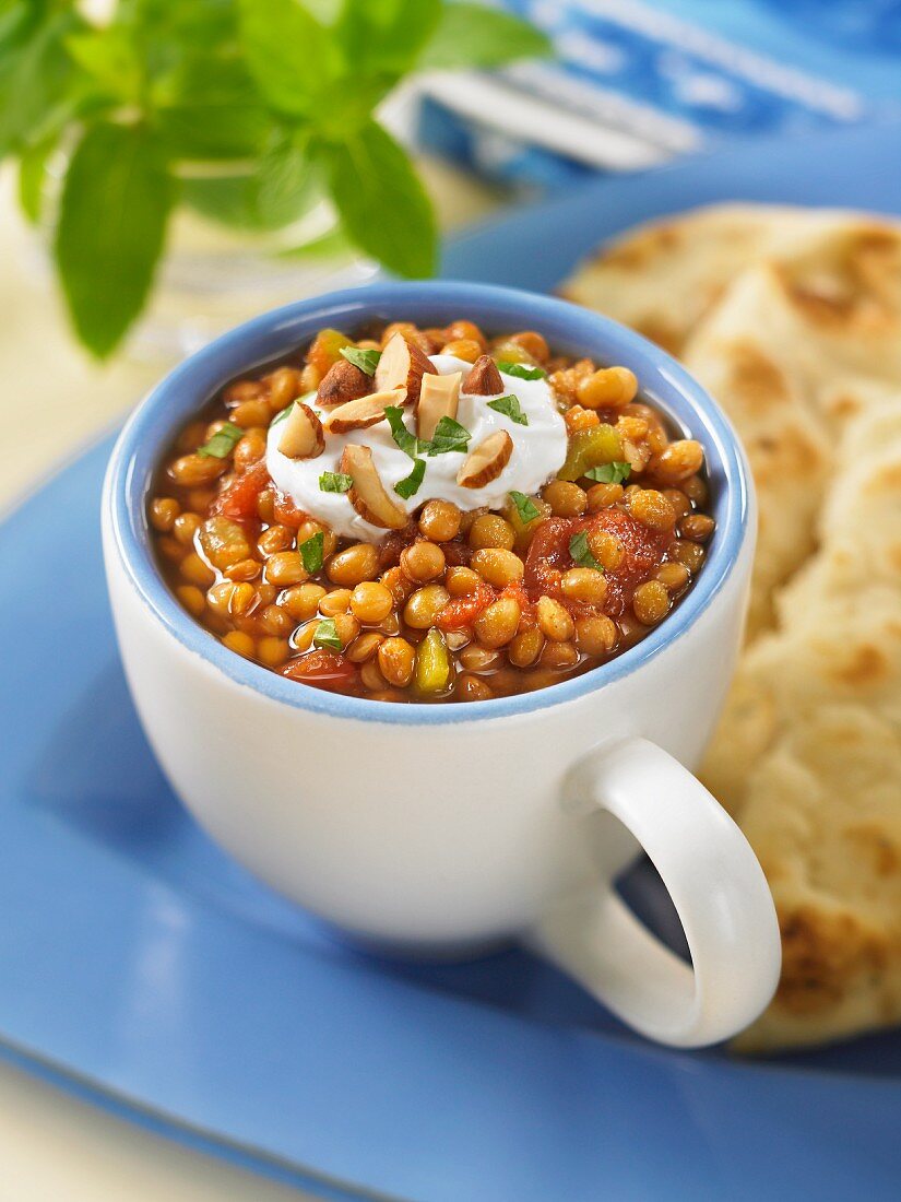 Spiced lentils with yoghurt, almonds and unleavened bread