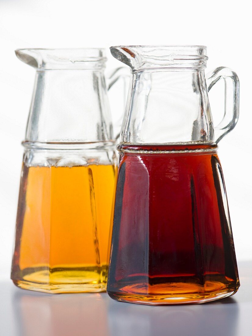 Two type of maple syrup in glass jugs