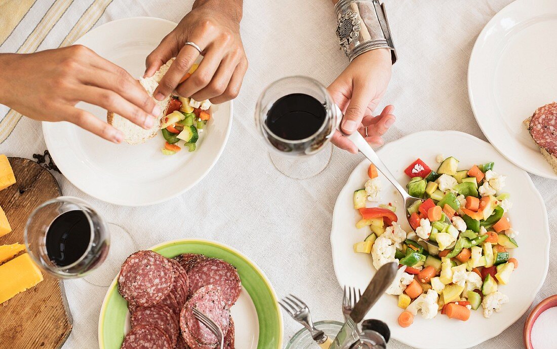 Hands serving salad