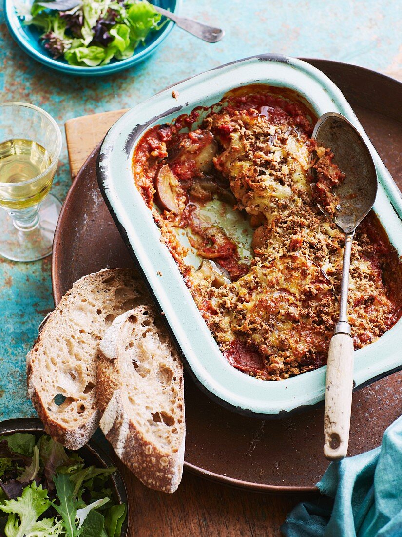 Aubergine and mozzarella bake with slices of bread