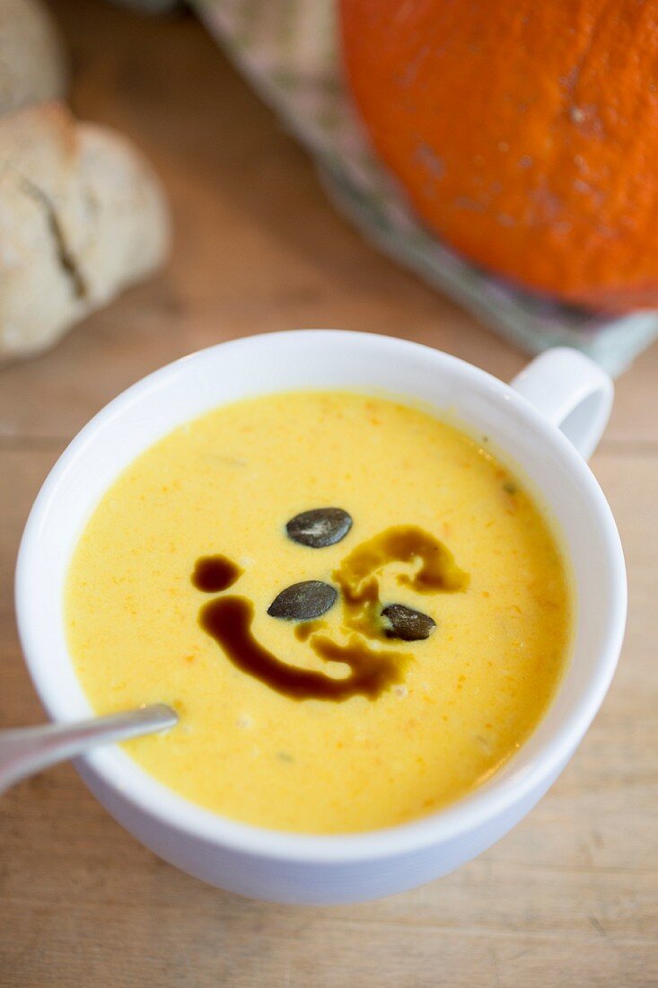 Cream of pumpkin and ginger soup with pumpkin seed oil and pumpkin seeds